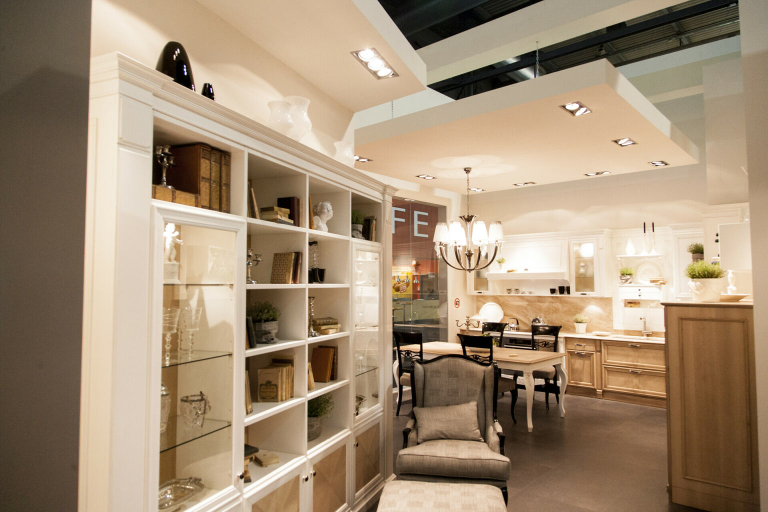 a room with a white shelving unit and a chair