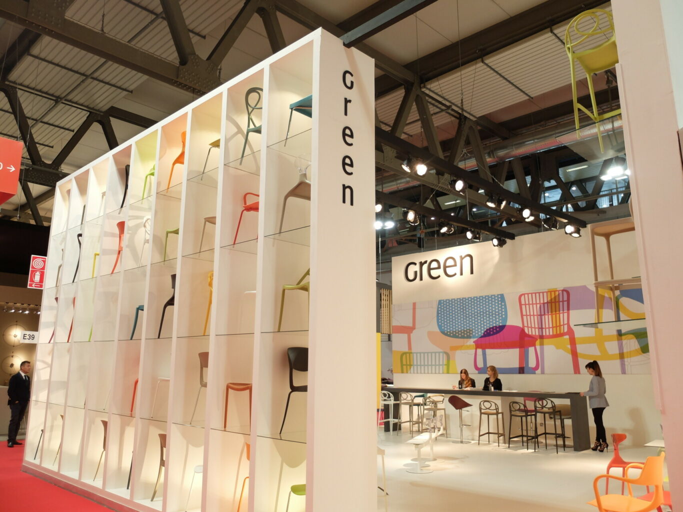 a white shelf with colorful chairs