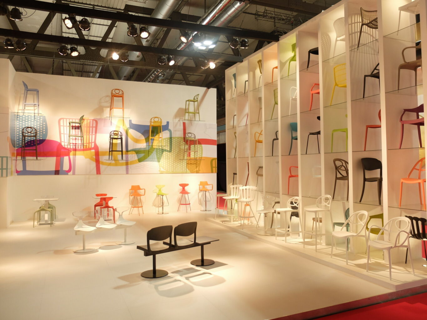 a room with white shelves with chairs and tables