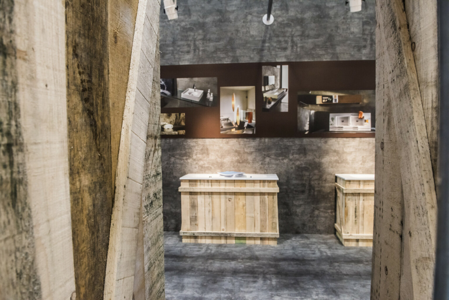 a room with wooden crates and pictures on the wall