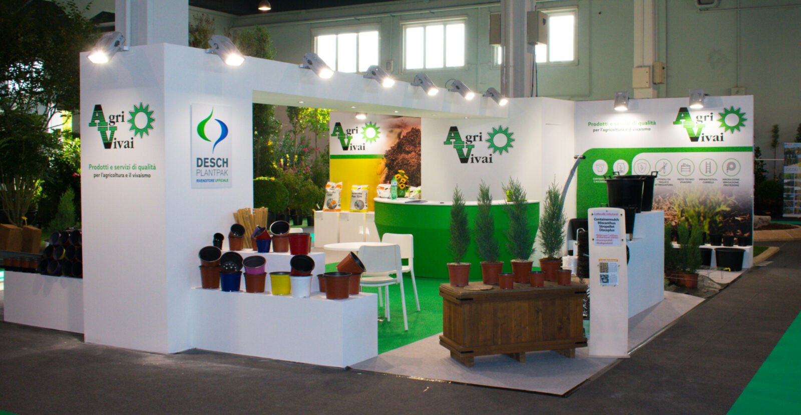 a booth with plants and a sign