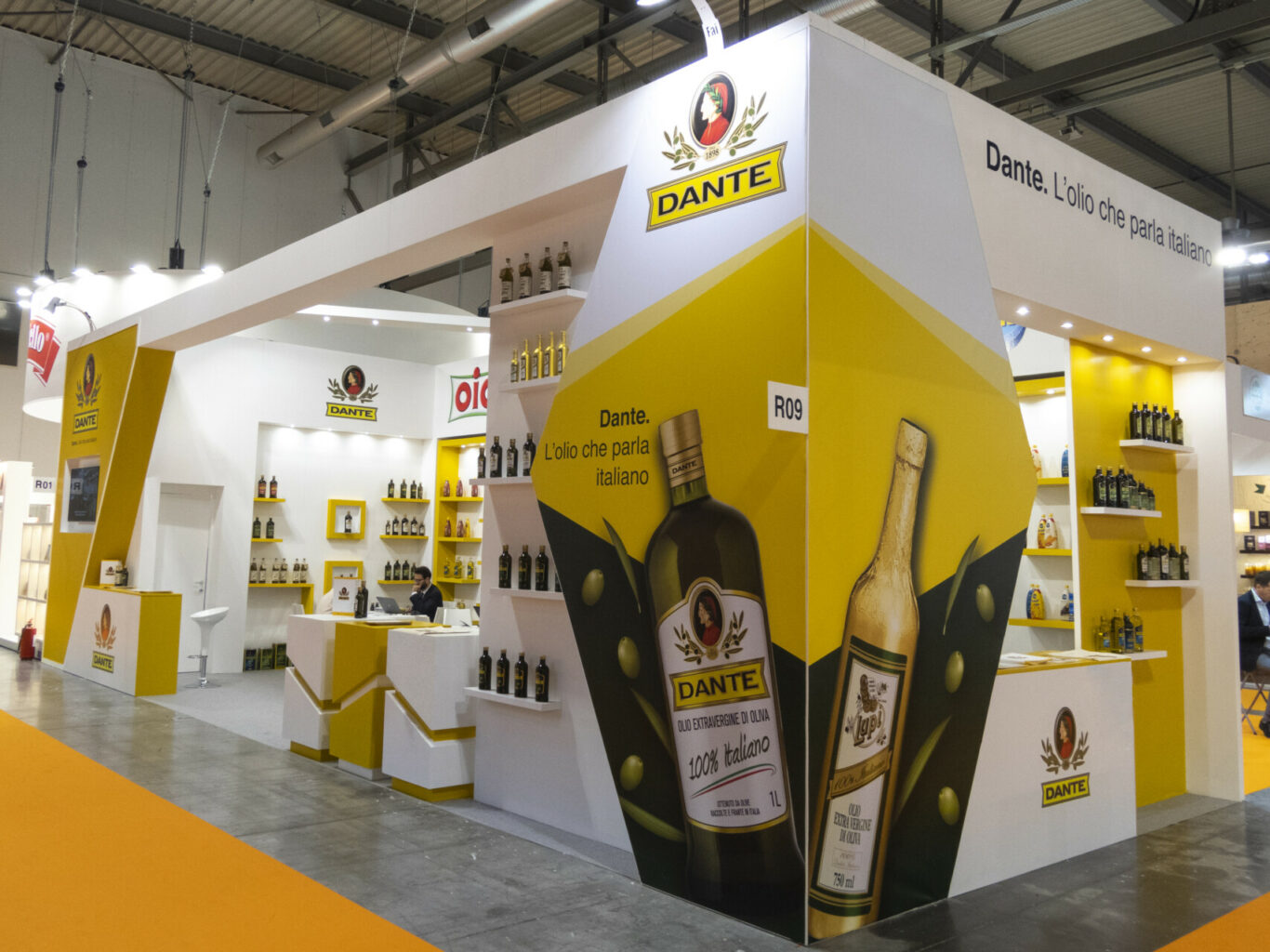 a white and yellow booth with bottles and a yellow and white background