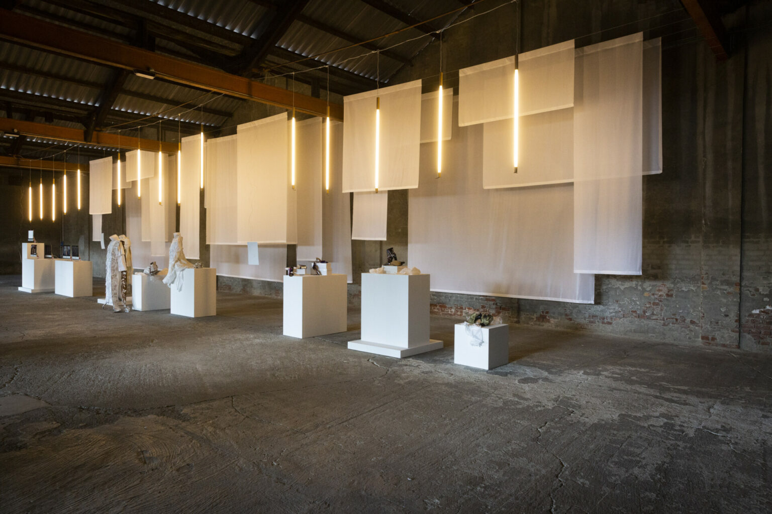 a room with white boxes and white curtains