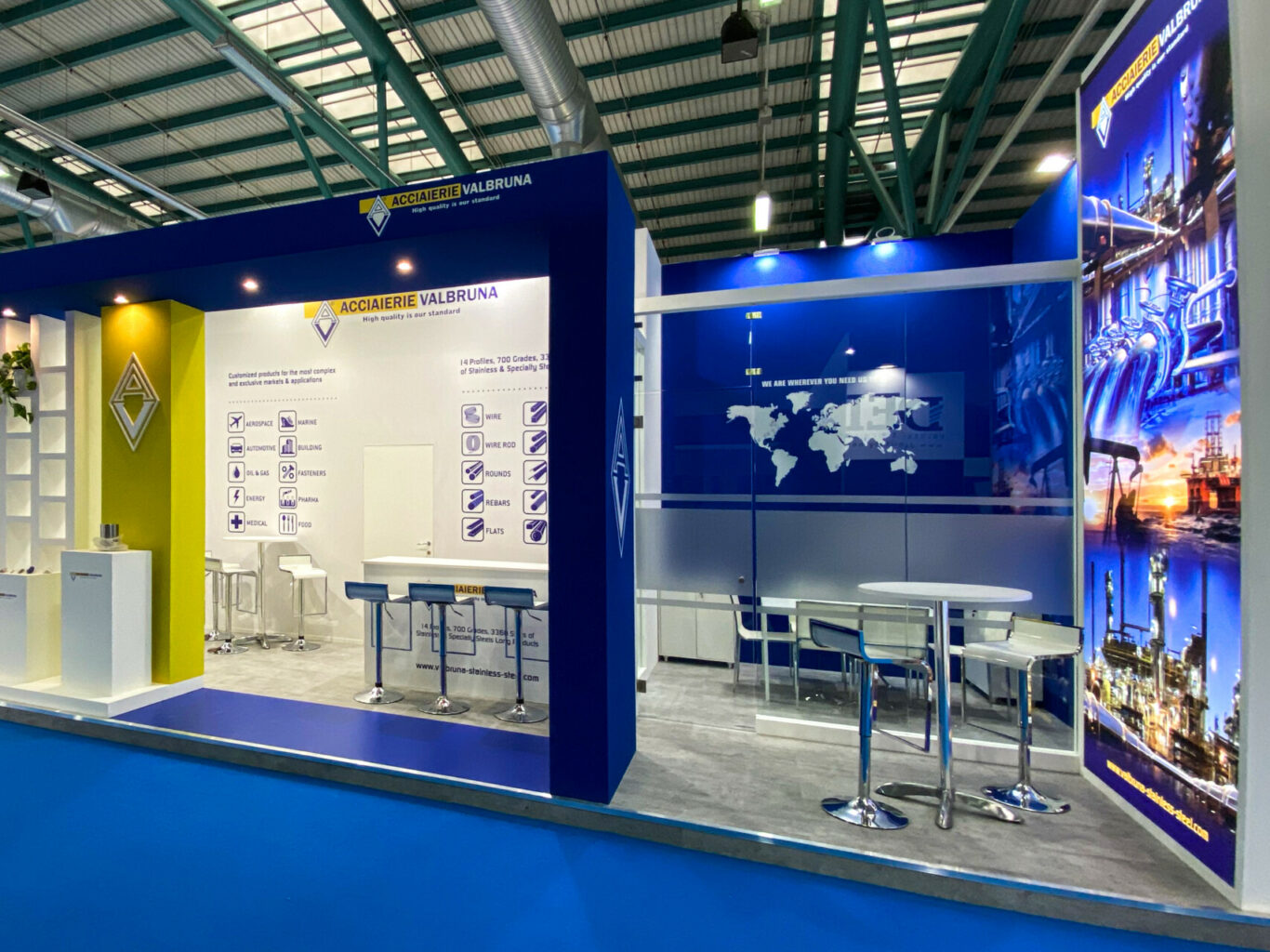 a blue and yellow booth with tables and chairs