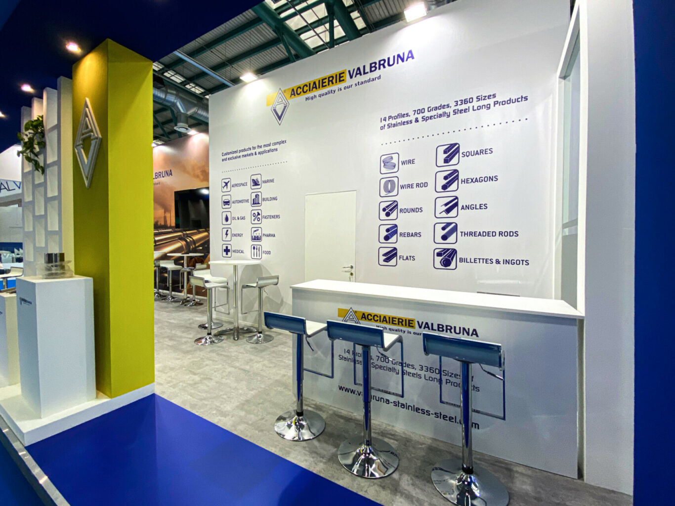 a white wall with bar stools and blue floor