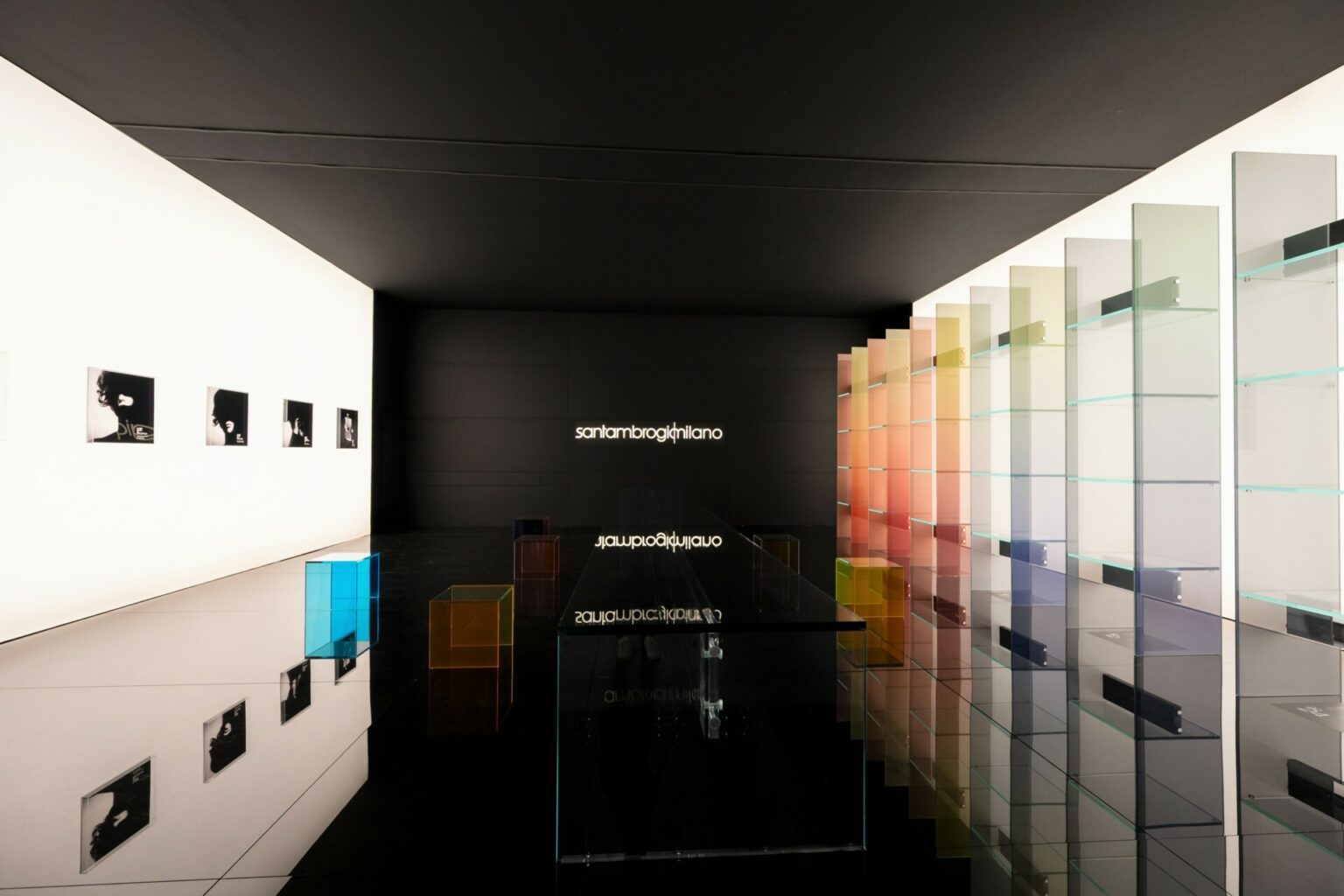 a room with glass shelves and pictures on the wall