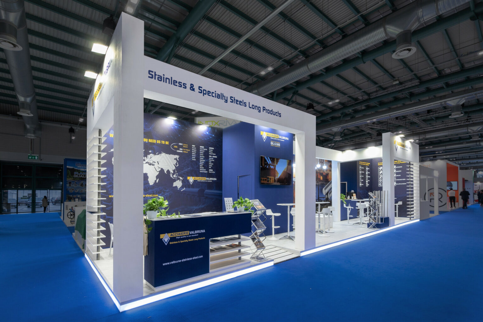 a white and blue booth with blue walls and white tables