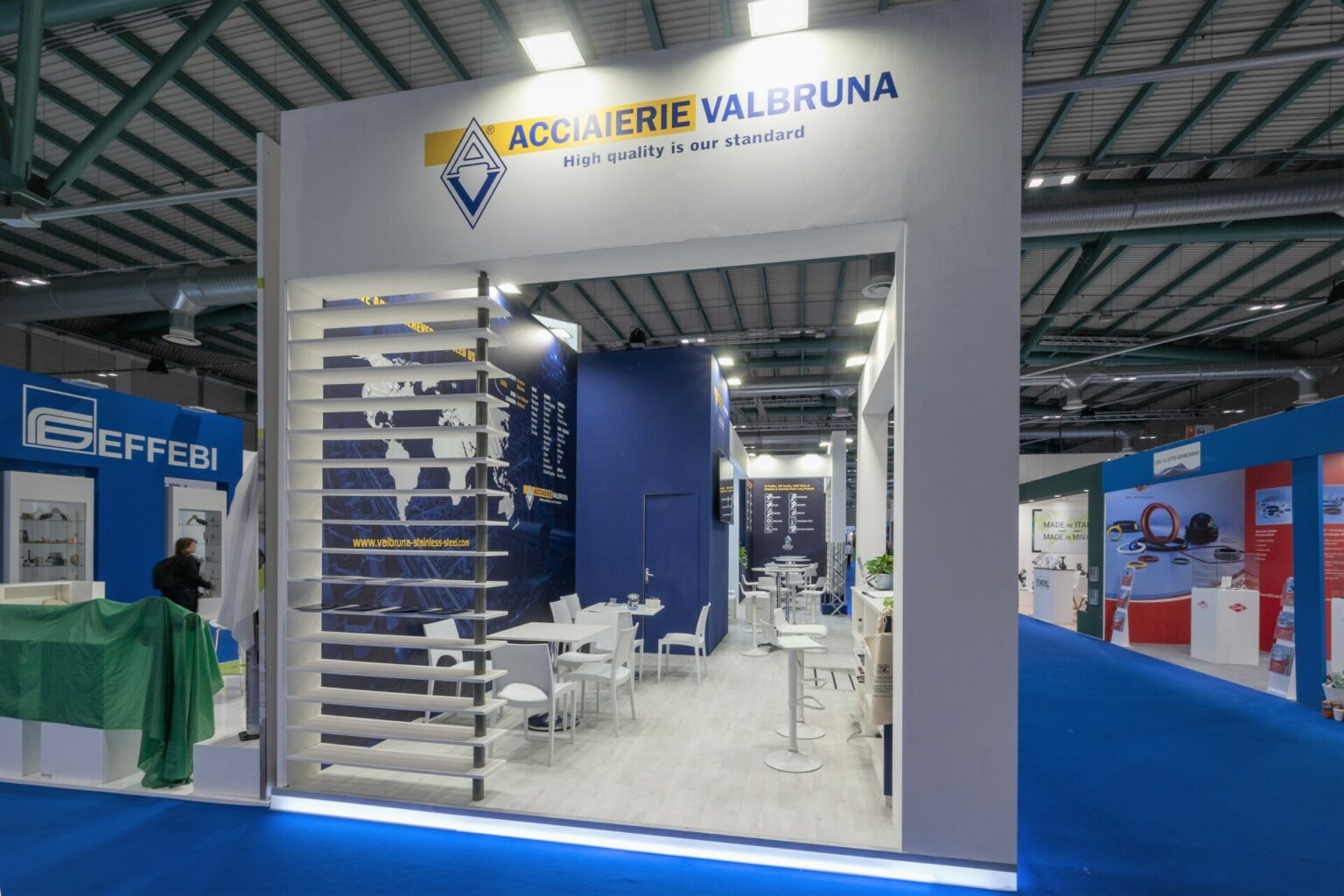 a white and blue booth with tables and chairs