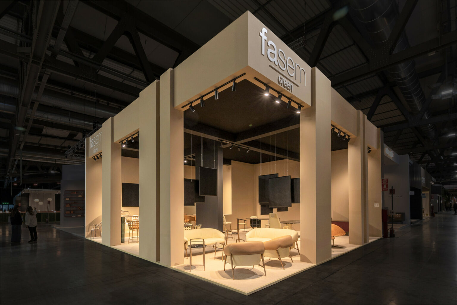 a white booth with a sign and chairs