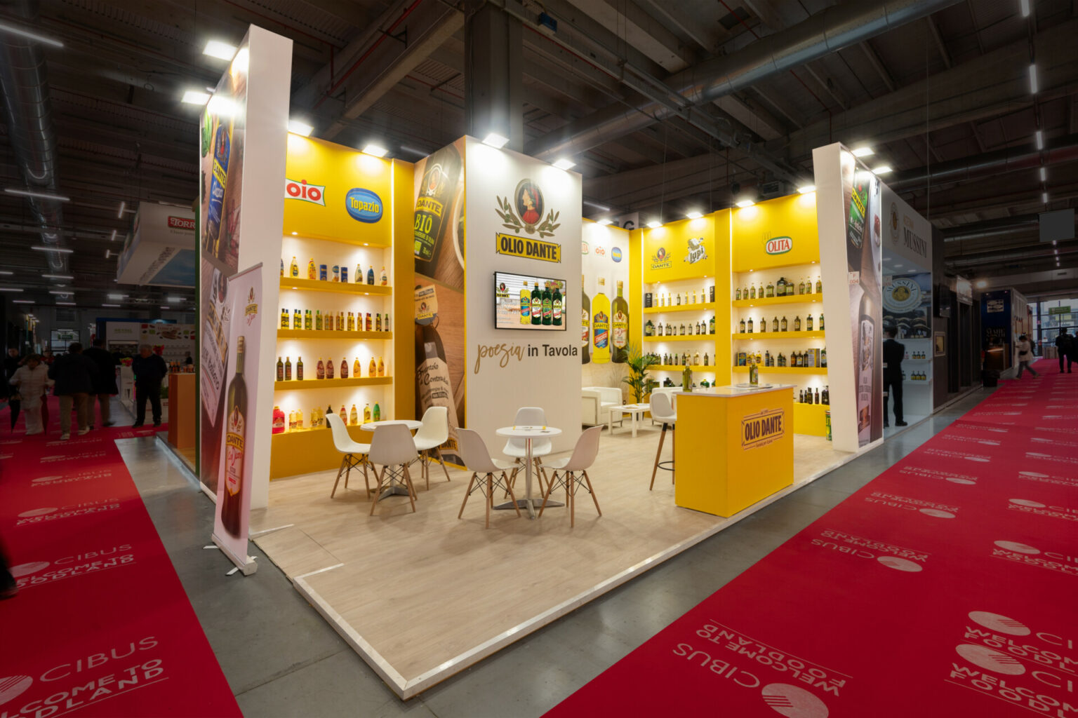 a yellow and white booth with tables and chairs