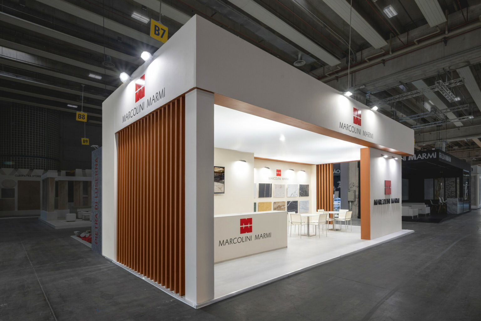 a white and brown booth with a sign