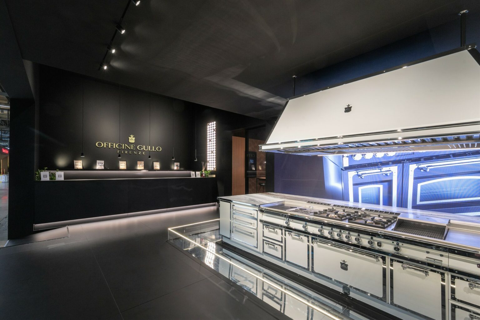 a large white stove in a room with a black wall and a black counter