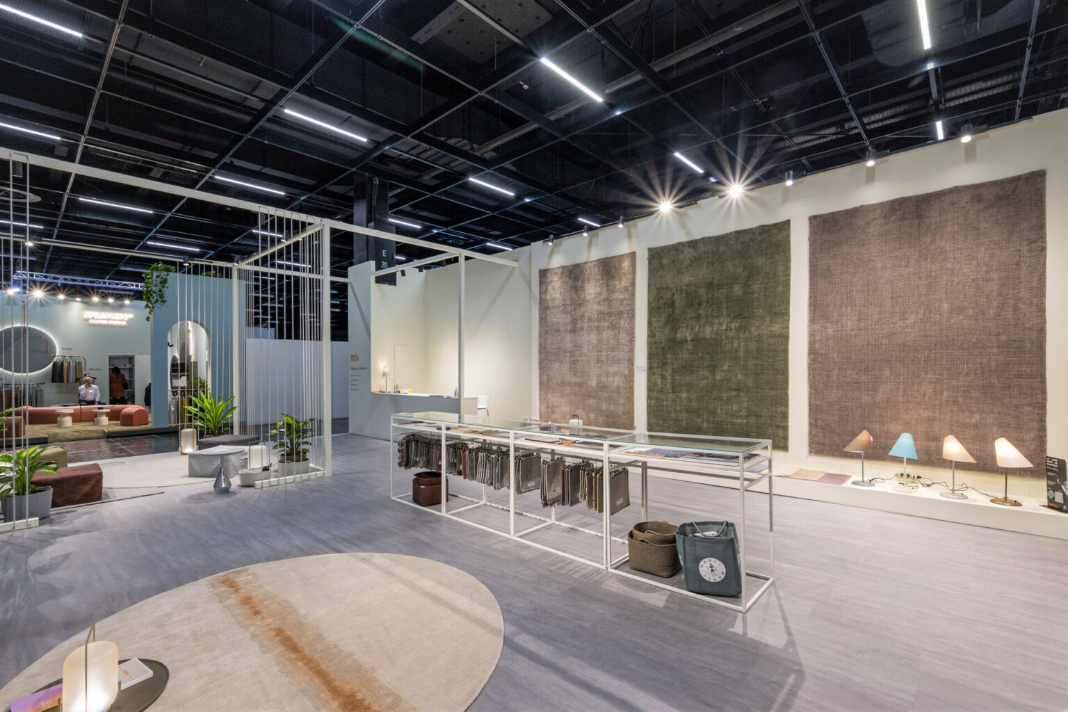 a room with a display of rugs and a mirror